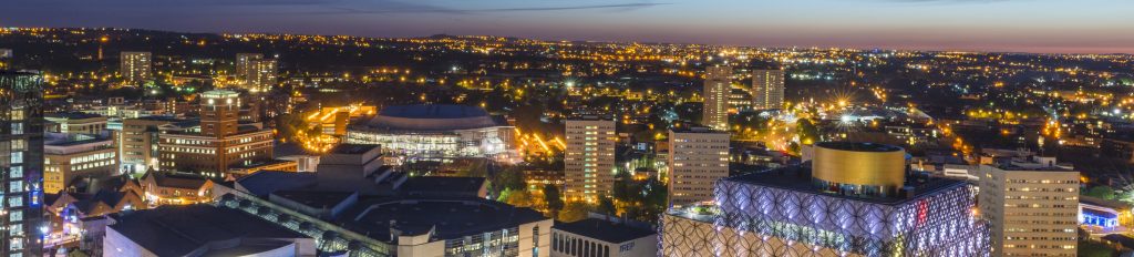A night view of Birmingham city centre at night, showing Centenary Square and the new library of Birmingham.